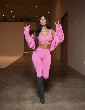 Kim Kardashian in pink outfit with black knee high boots
