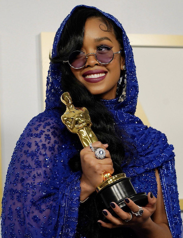Music Artist H.E.R. holds her Oscar award